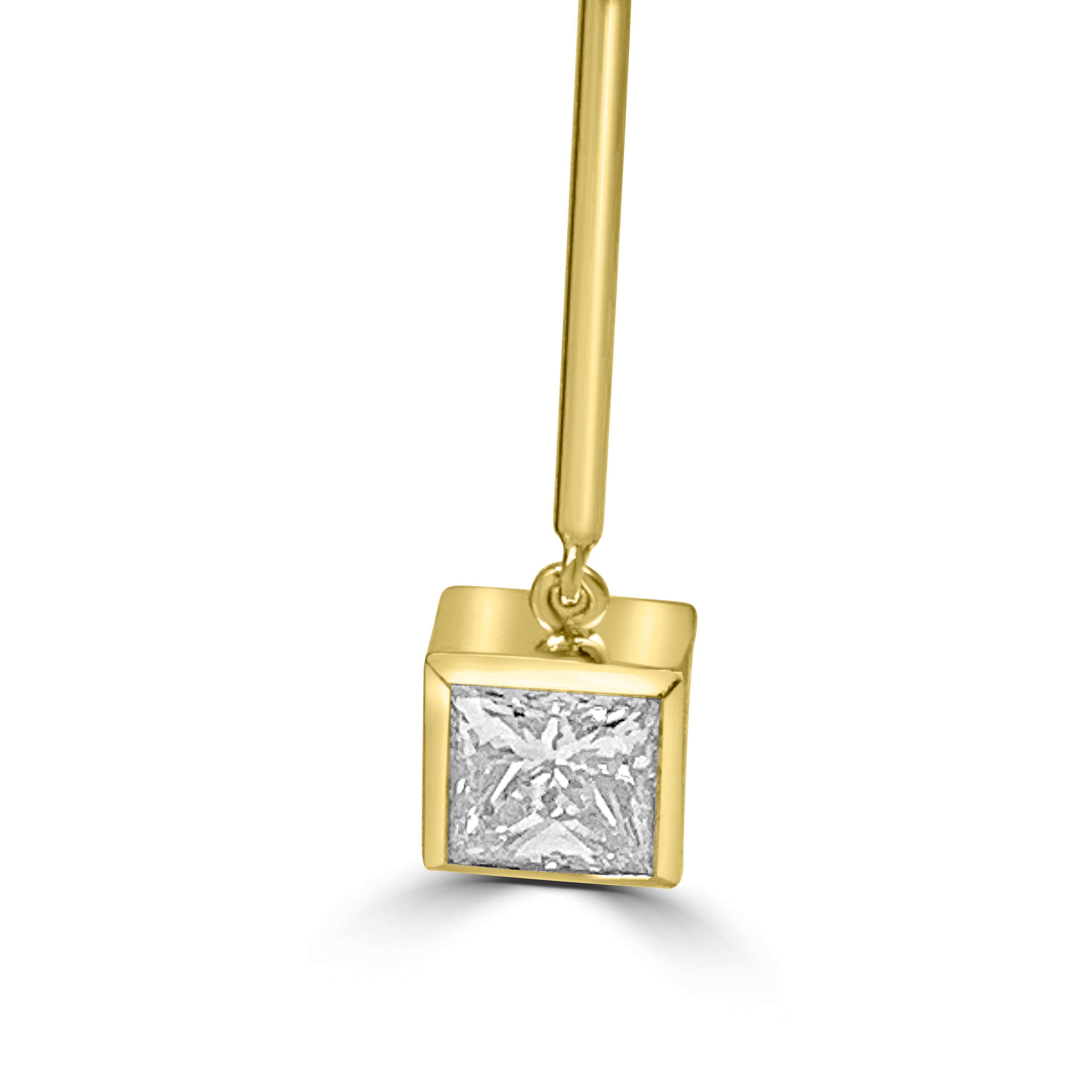 princess cut diamond earrings hanging on a long gold