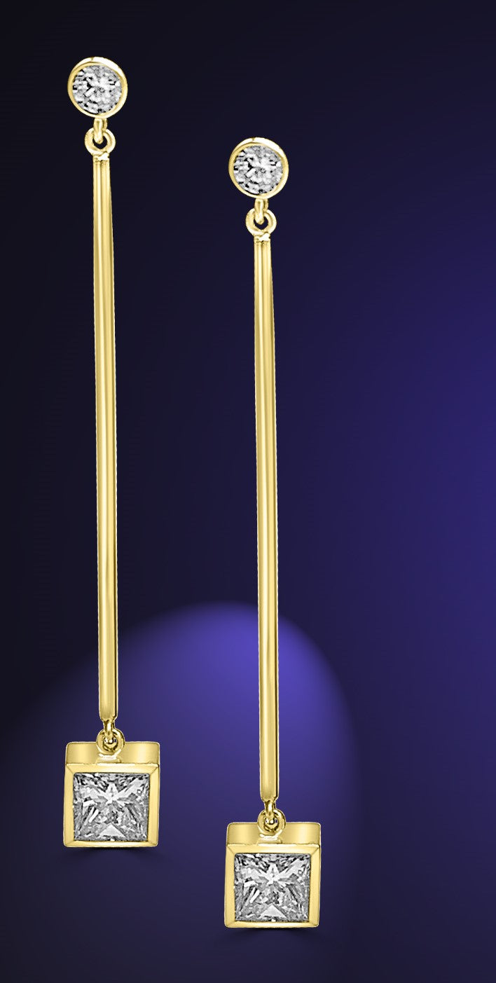 princess cut diamond earrings hanging on a long gold