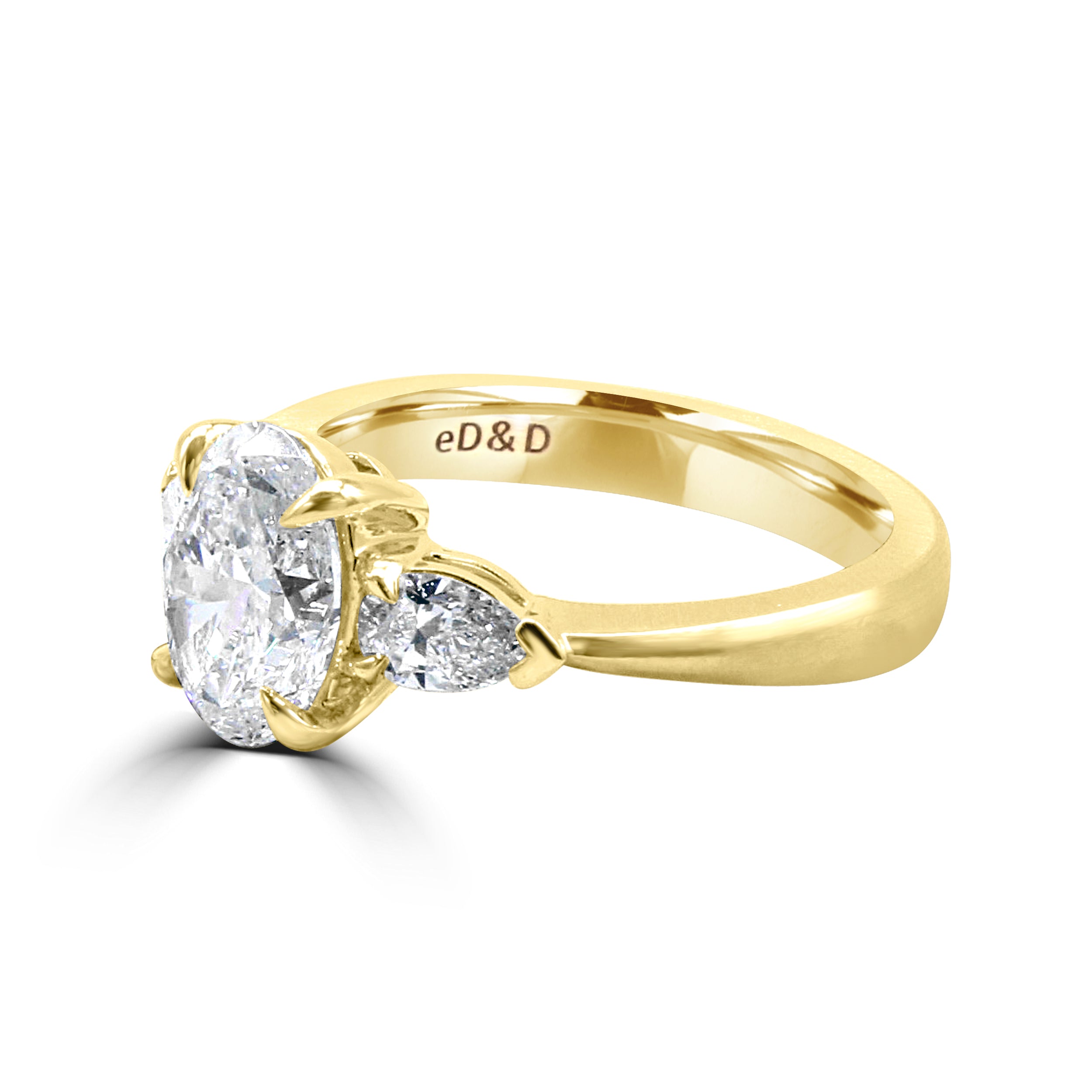 oval diamond with two pear side stone diamond ring