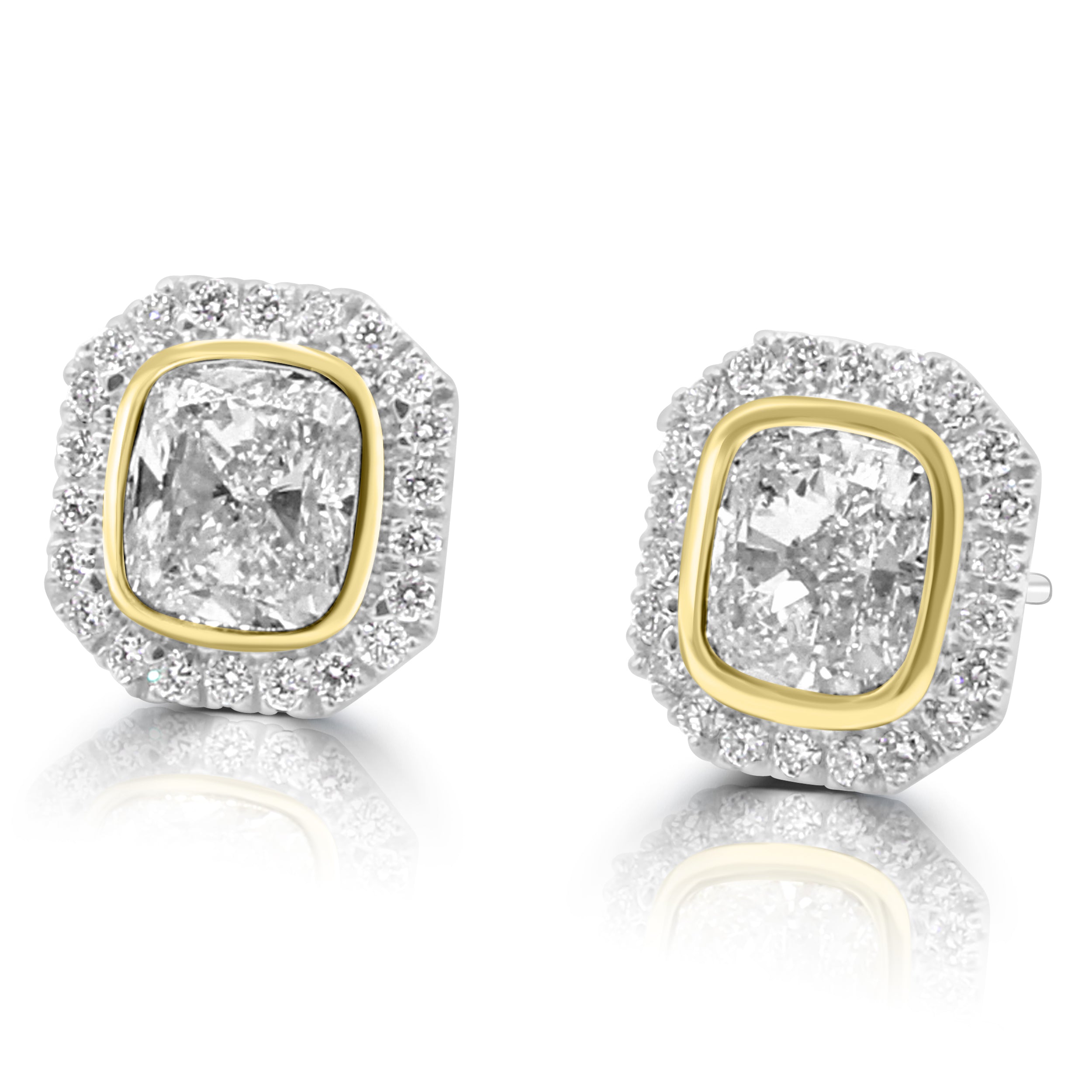 Cushion cut diamond set bezel set in yellow gold with pave diamond halo on white gold. earrings