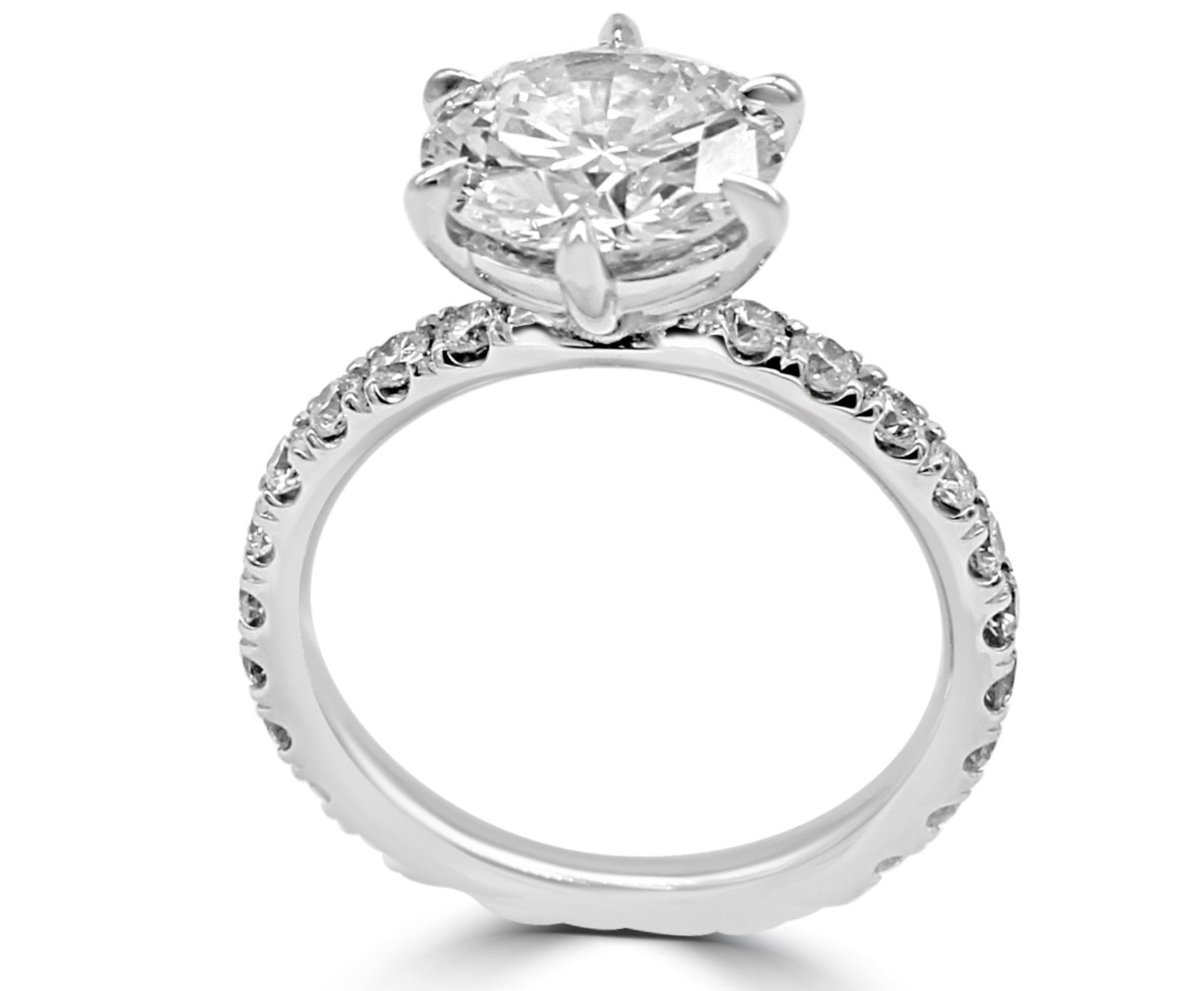 ow, rounded setting ring with a 3 ct diamond in the center, six prongs for security, and a diamond-covered band for extra sparkle