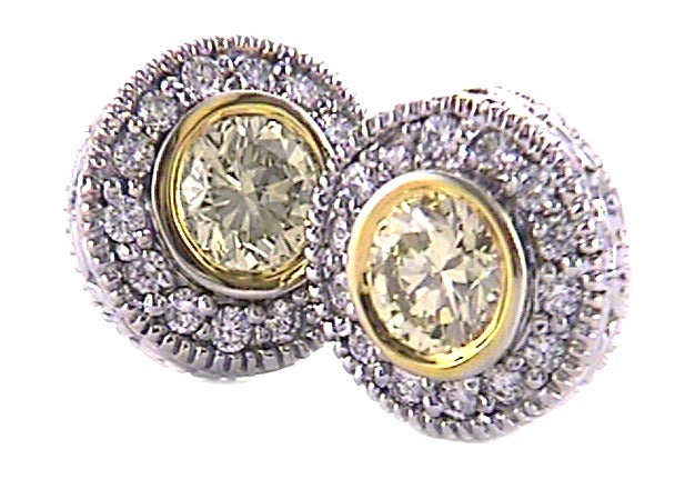 vintage-style, custom-made earrings featuring fancy yellow round diamonds, blending an antique look with modern luxury