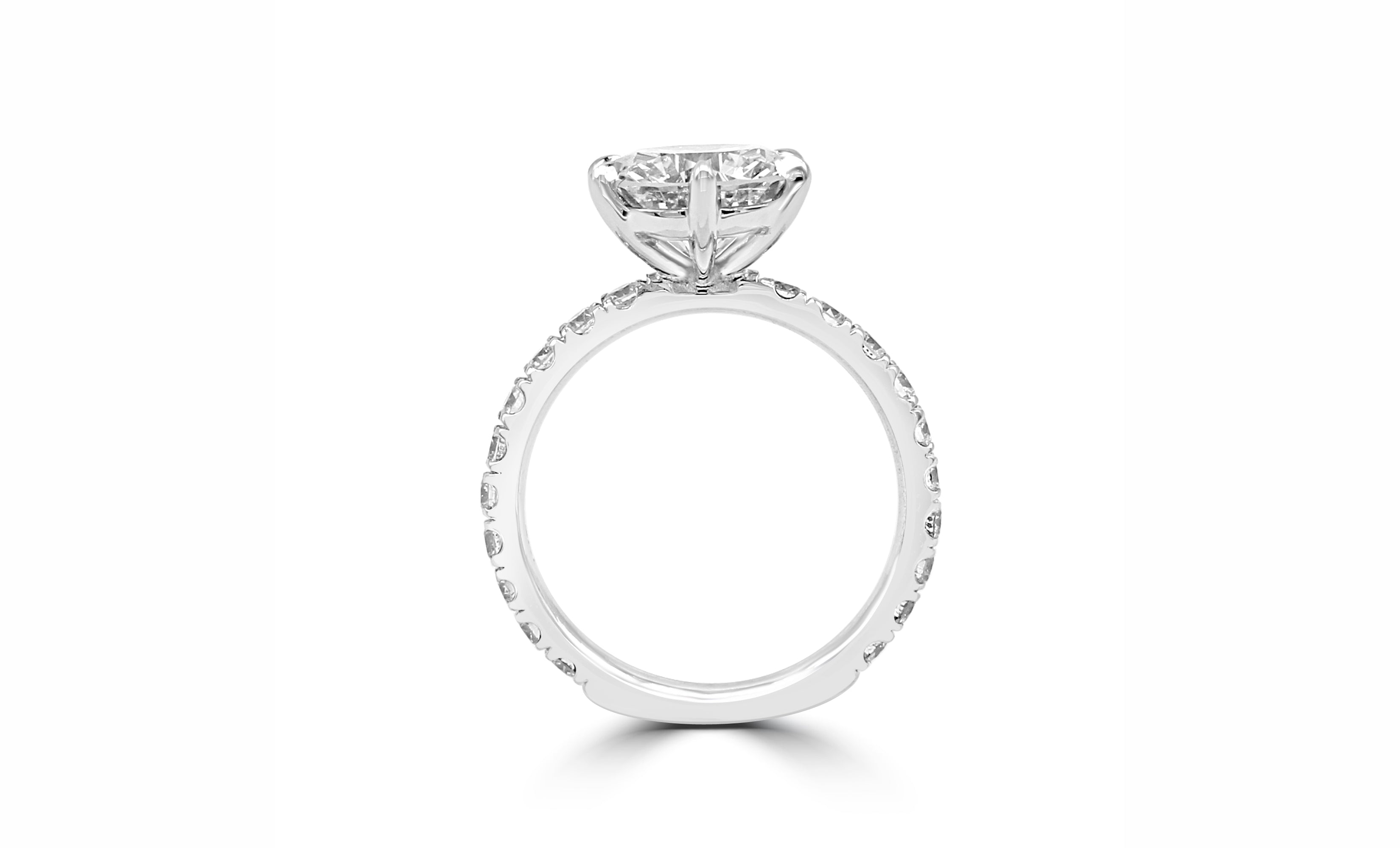 ow, rounded setting ring with a 3 ct diamond in the center, six prongs for security, and a diamond-covered band for extra sparkle