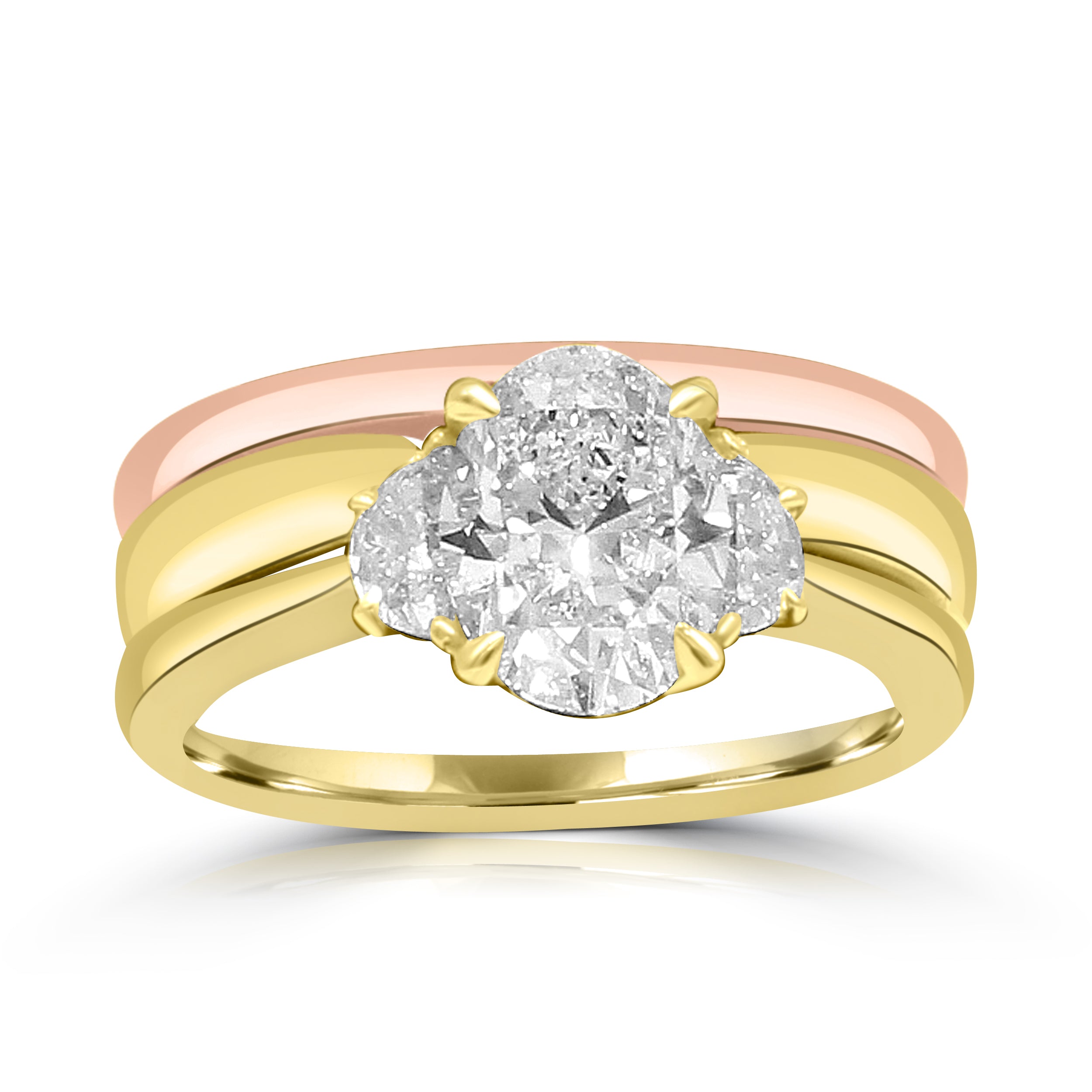 A two-tone gold ring featuring three oval-cut diamonds in a trilogy setting. The ring has a yellow gold band with a rose gold accent band, showcasing a sleek and elegant design with sparkling diamonds as the focal point.