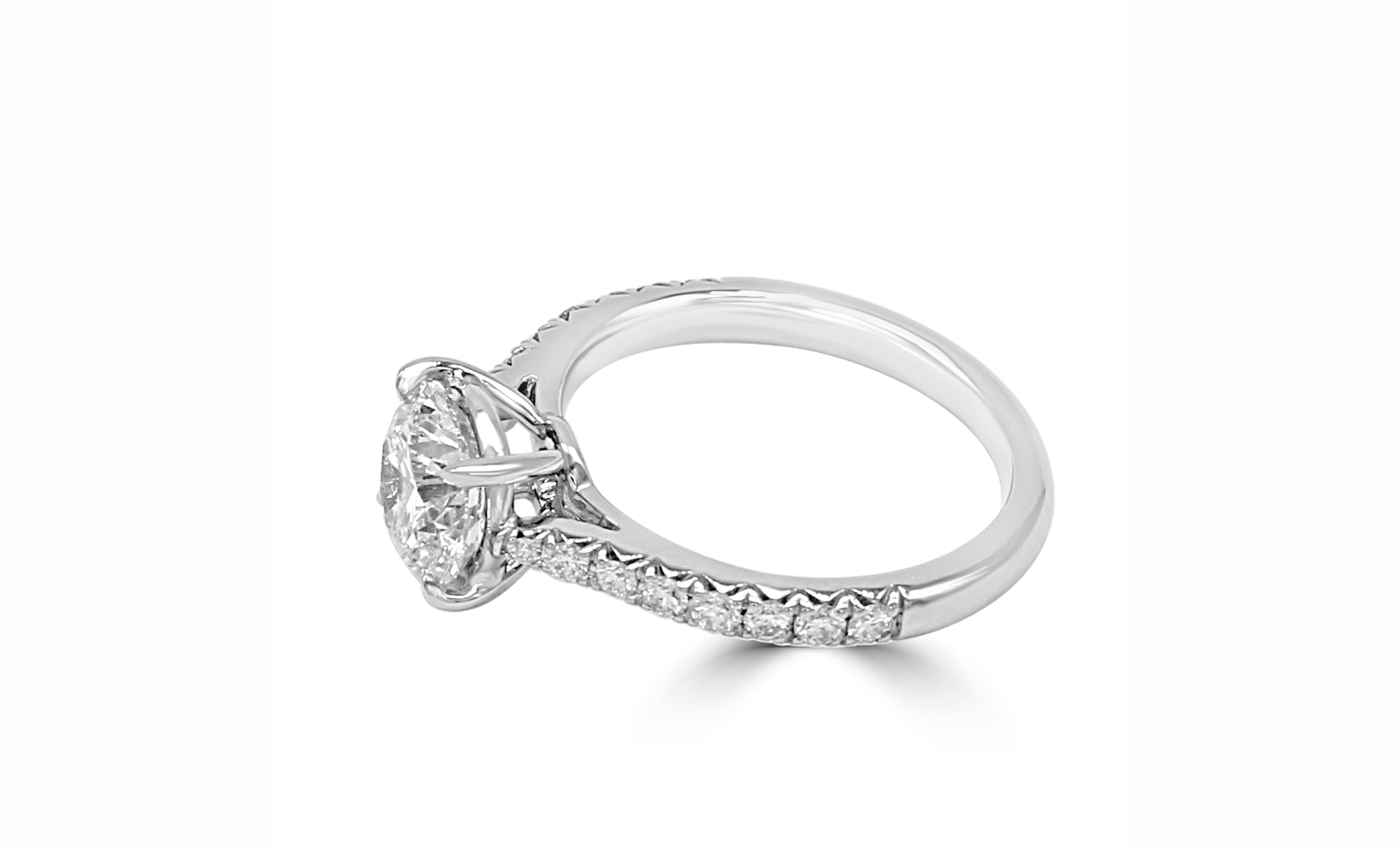 Low-profile ring with French-cut side stones and a center diamond.