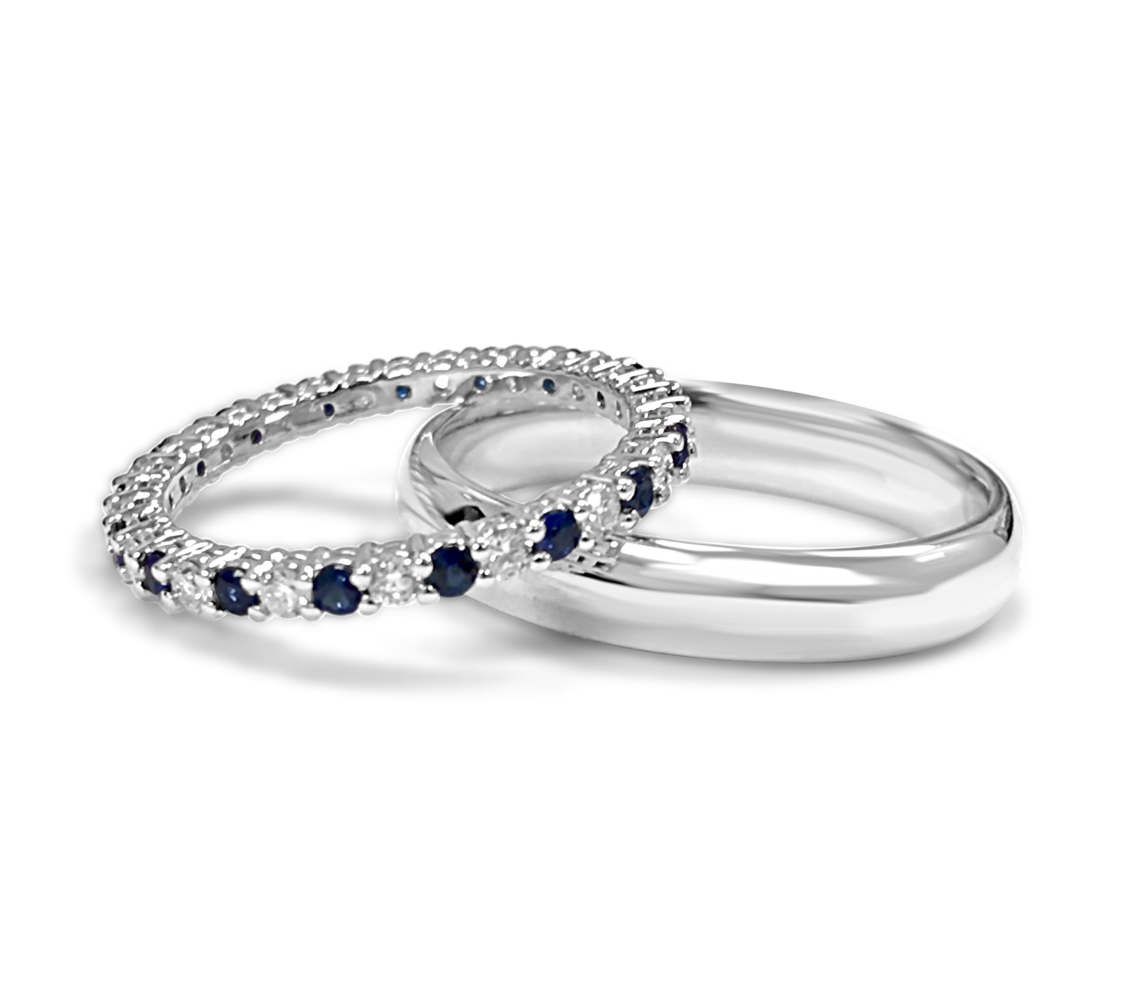 diamond and blue sapphire ring on top of platinum band