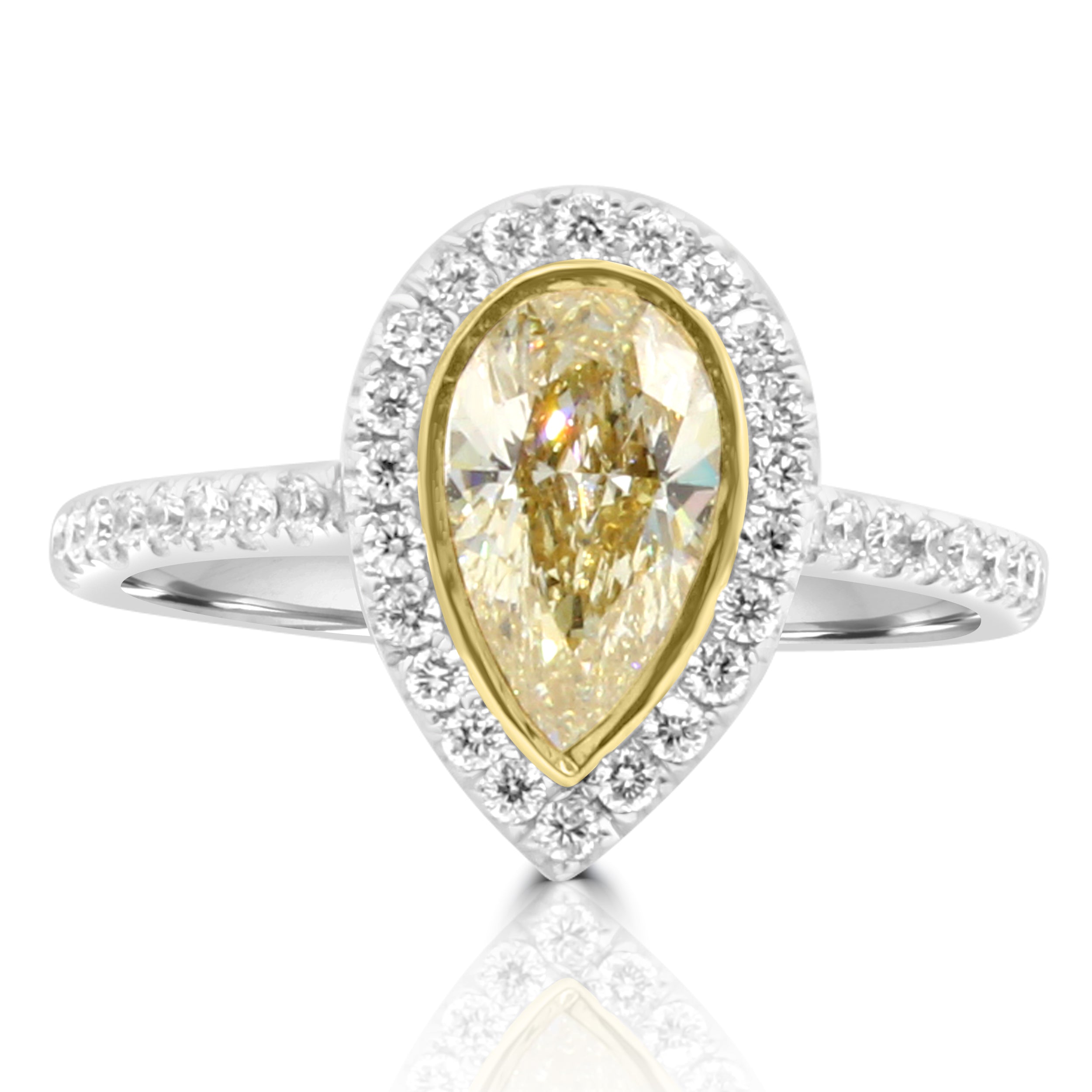 Yellow Pear Shape diamond is set in a custom made ring with a diamond halo and pave band