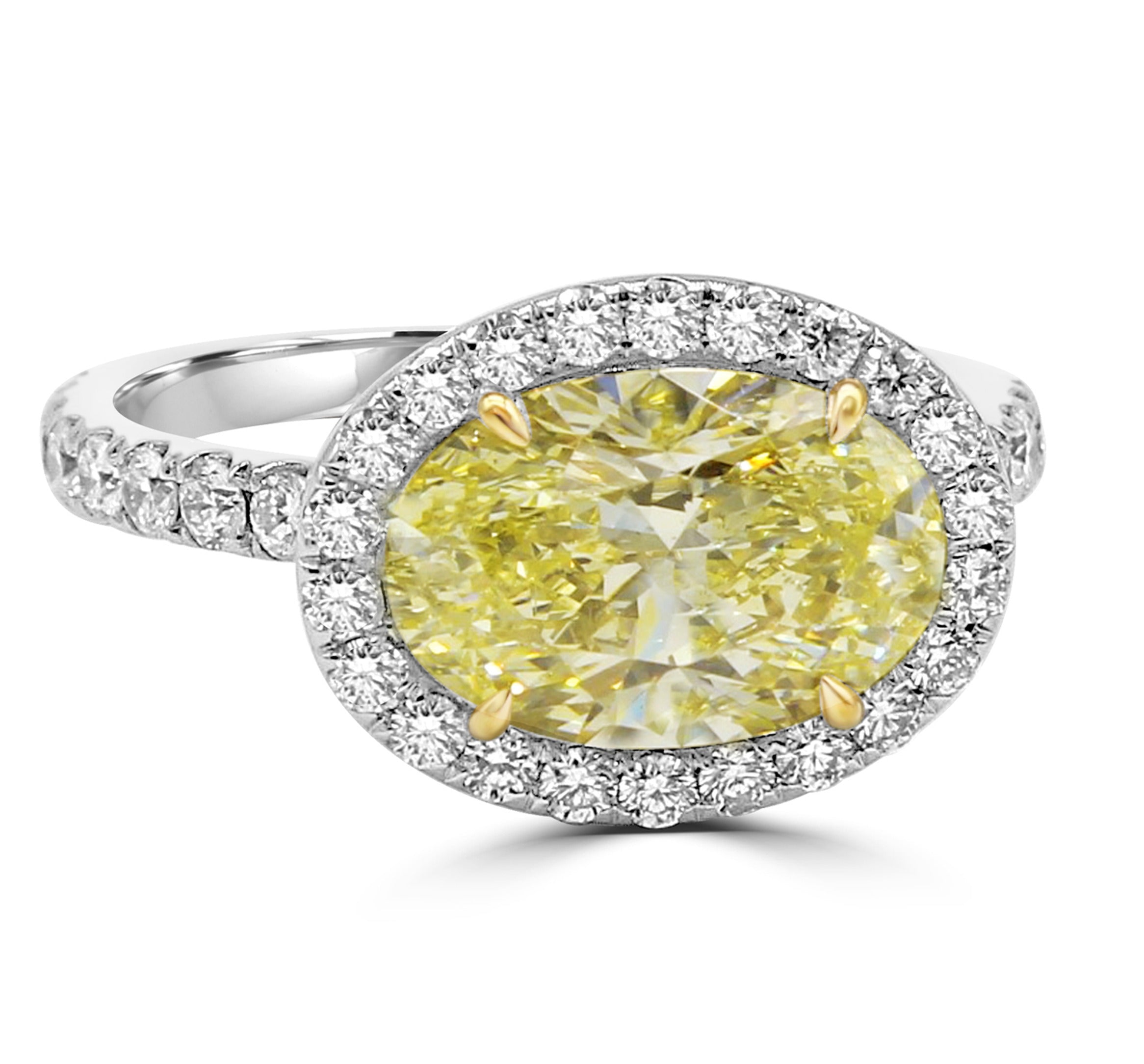 Yellow Oval diamond centerpiece with pave halo and shank