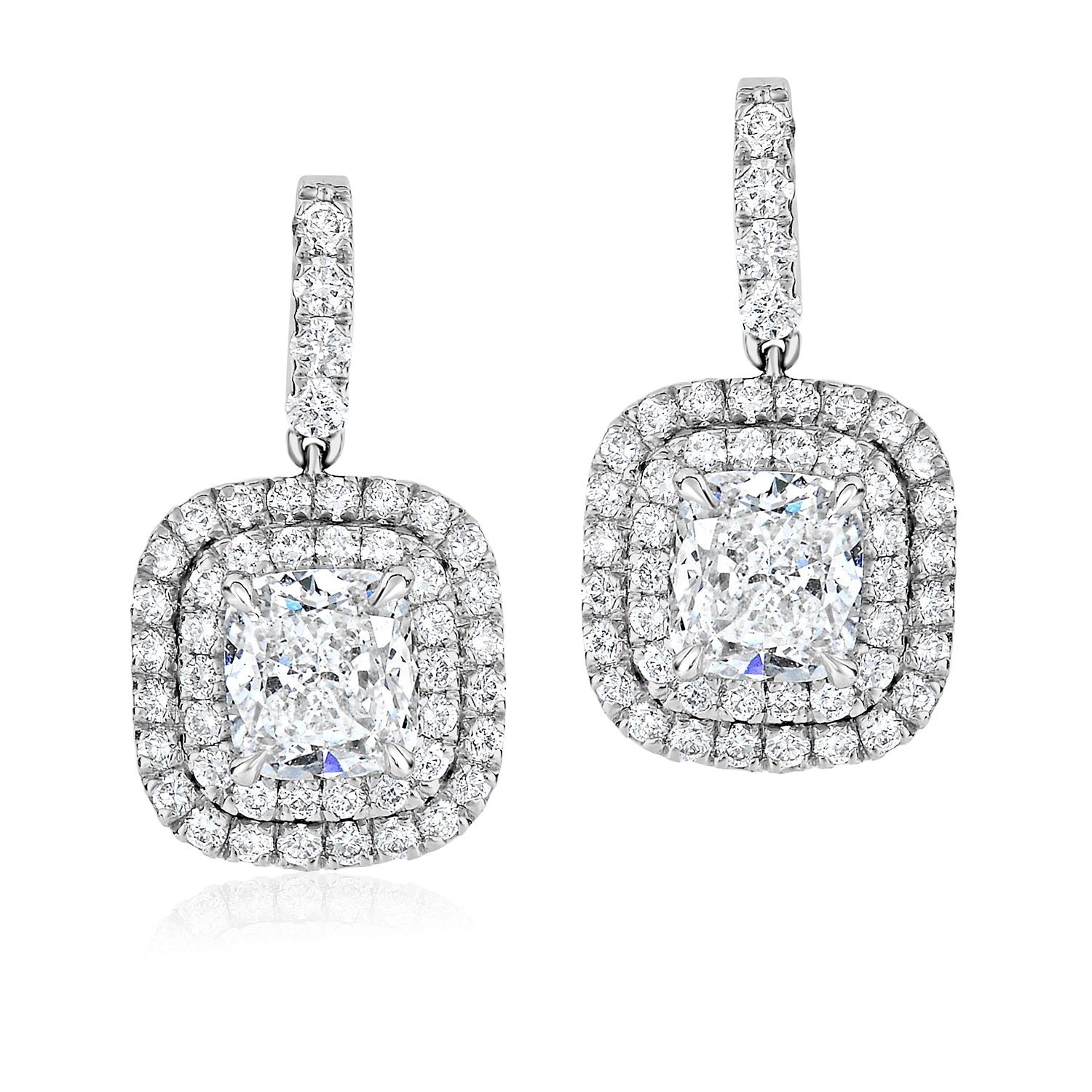 Cushion-cut diamond halo earrings with accent diamonds.