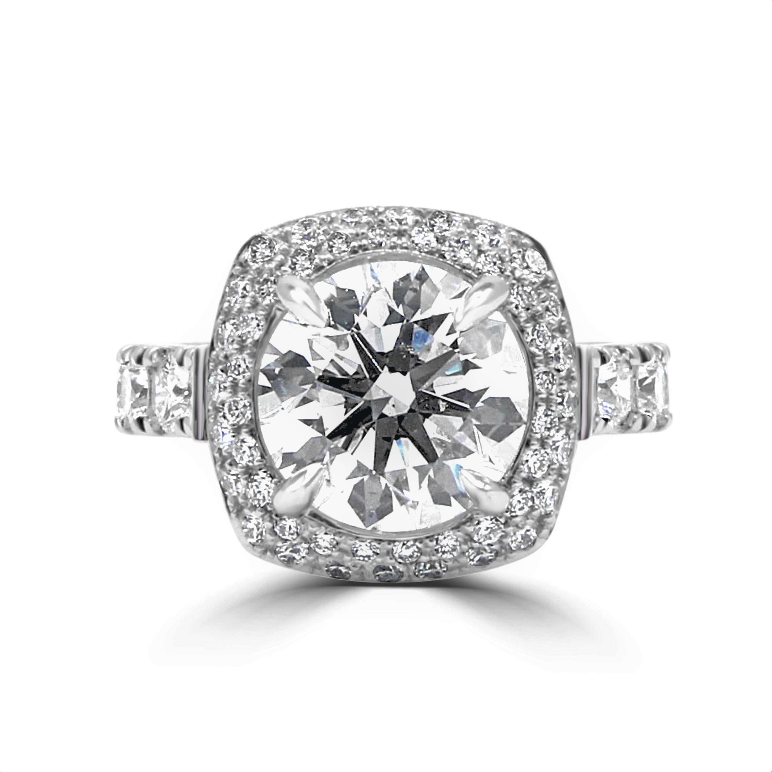 center large diamond- 4CT with double halo and large diamonds on shank