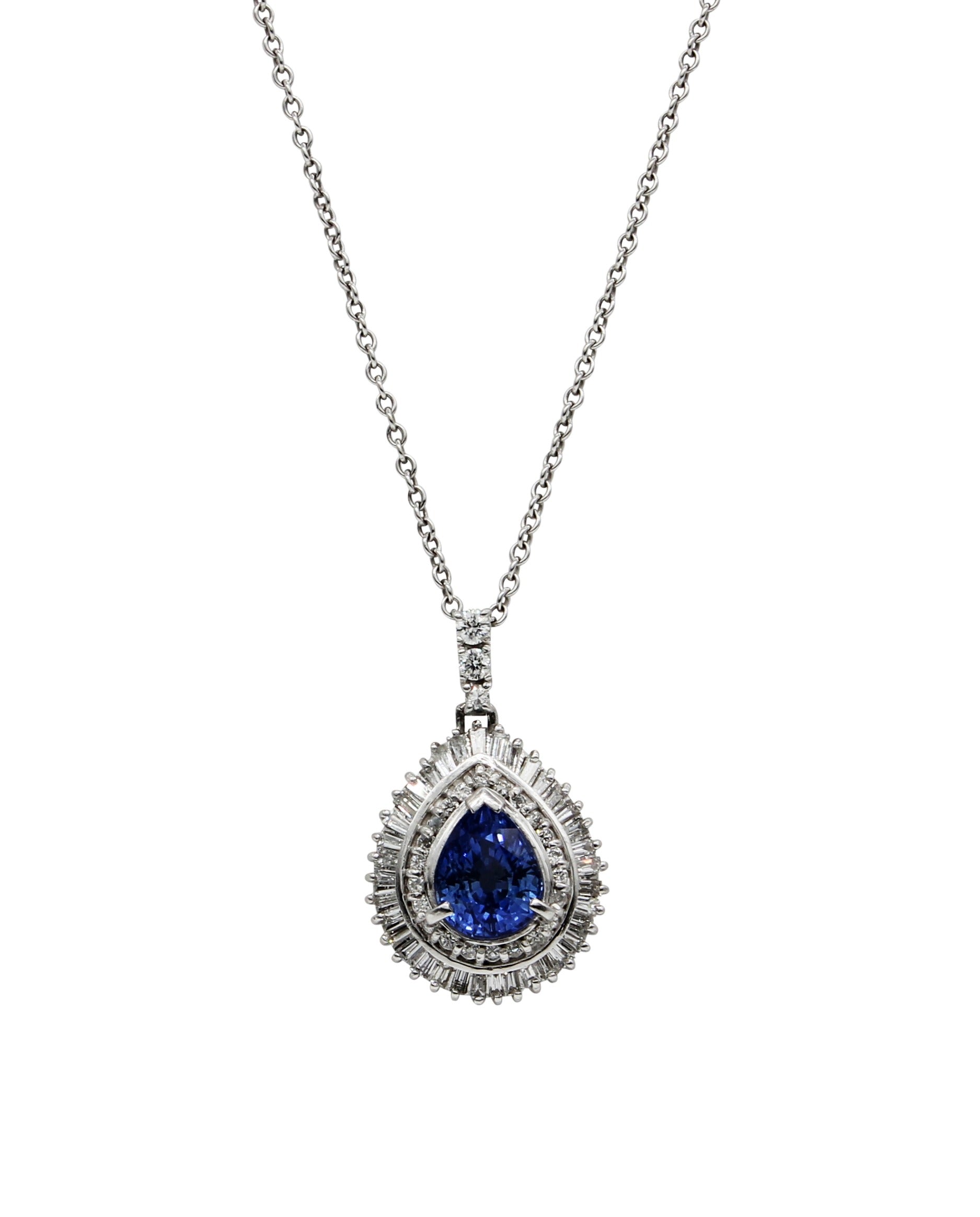 Blue Sapphire all Natural, surrounded by Baguettes and Round diamonds.